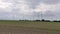 Plowed field with wind turbines in the background. Zornheim, Mainz, Germany.