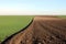 Plowed field and young green wheat sunny autumn day landscape