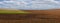 plowed fields, gardens in the evening light and cloudly sky