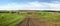 plowed lands with green winter wheat, spring field relief hilly landscape