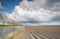 Plowed potatto field and windmill turbines