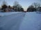 Plowed road in snowy suburb