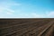Plowed soil. Agricultural rural background. Plowed field in early spring