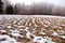 Plowed winter farmland field covered snow