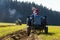 Plowing vintage veteran tractors on field on ploughing championship