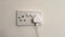 Plug in electrical appliance and switch on, UK British socket