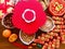 A plum blossom shaped candy box and the firecracker decorations on wooden brown background for the Ox year Lunar New Year.