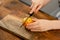 Plum perfection: A boy skillfully cutting a succulent, golden plum on a rustic wooden surface