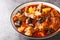 Plum stew with lamb, prunes, tomatoes, carrots, onions, potatoes and spices close-up on a plate. horizontal