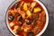 Plum stew with lamb, prunes, tomatoes, carrots, onions, potatoes and spices close-up on a plate. horizontal top view