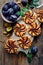 Plum tarts with cinnamon on a wooden table, delicious dessert with puff pastry and fruits