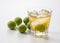 Plum wine and unripe plums on a white background