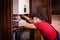 Plumber adjusts gas boiler before operating