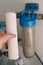 Plumber change water filter. Replacement aqua filter. Technician maintenancing system of water filtration