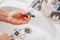 A plumber cleans a water purification filter in faucet faucets in a washbasin