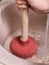 Plumber clears water blockage in kitchen sink
