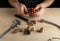 Plumber connects brass fittings while repairing equipment. Close-up of the hand of the master during work