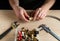 Plumber connects brass fittings while repairing equipment. Close-up of the hand of the master during work