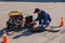 Plumber diagnoses a drain well on the street using special equipment