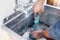 Plumber, drain and man with plunger for sink, maintenance and repairs, blockage or cleaning. Plumbing, drainage and