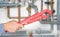 Plumber holding pipe wrench with pipe system in background blur