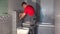 Plumber man draw water from pipe of toilet flushing mechanism