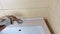 A plumber removes a faucet from a sink. Plumbing. Concept of home maintenance, minor repairs and maintenance in the