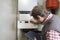 Plumber repairing a condensing boiler