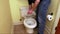 Plumber`s hand repairing toilet seat