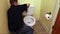 Plumber`s hand repairing toilet seat
