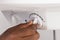 Plumber`s Hand Turning The Knob Of Electric Boiler