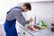 Plumber Using Plunger In Sink