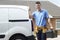 Plumber With Van Talking On Mobile Phone Outside House