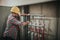 Plumber welded plastic pipes. Worker with construction helmet Is standing on the cbuilding site and does not know what