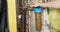 Plumbing cabinet, a man opens a water supply tap through a coarse filter.