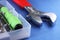 Plumbing tools on blue table. Bits for screwdriver, screwdriver, adjustable wrench on a blue background close up.