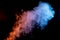 A Plume of Blue, Red, and Yellow Smoke Overlaid on a Black Background