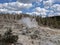 Plume of steam rising from rocks at Yellowstone National Park