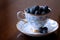 Plump Blueberries in a Porcelain Tea Cup