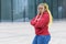 Plump, fat black African American serious girl with creative yellow hair, angry young woman crossing her hands