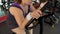 Plump female working stationary bike in sports club, body fitness