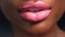Plump passionate lips on dark-skinned girl, close-up. Sexy glossy lip makeup. Beautiful makeup, pink lipstick and gloss