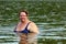 Plump woman bath in river
