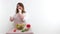 plump woman chef tosses a cherry tomato sexy eats it smiles makes eyes on a white background space for advertising text