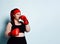 Plump young girl in black sporty top, shorts and red boxing gloves looks up thinking over strategy in forthcoming fight.