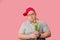 Plump young man with mournful eyes waiting for girlfriend with flowers