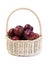 Plums in basket on white background. Fresh plums in a wicker basket on white background. Plums fruit heap in basket on white