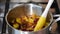 Plums boil in syrup during the preparation of plum jam.