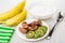 Plums, kiwi in plate, bananas, bowl with soft cottage cheese