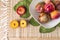 Plums pieces in wood table with green leaf